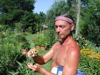 Picture of Larry Bowman holding Quilled Sweet Coneflower plant.