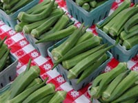 Picture of several containers of fresh cut okra.