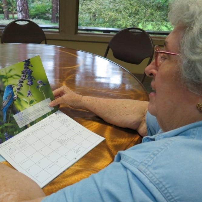 Photo of Jefferson County Master Gardener viewing the Master Gardener Calendar