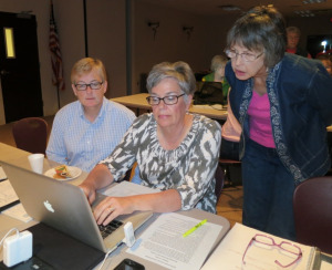 Master gardener volunteers Master gardener volunteers working at a computer